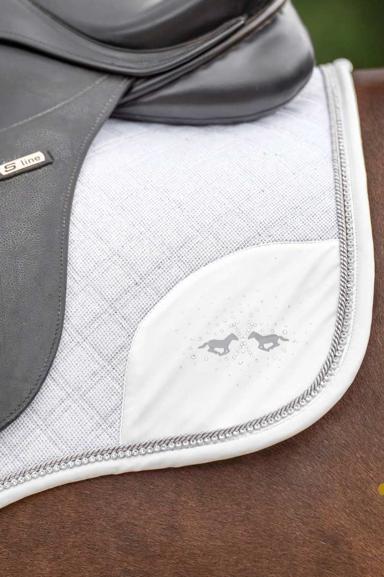 Pferde Springschabracke "Skye" von HV POLO in der Farbe Weiß mit der Artikelnummer 0801093504-0001. Diese Springschabracke wurde speziell entwickelt, um Ihrem Pferd während des Springreitens einen eleganten und komfortablen Sitz zu bieten. Sie können diese Pferde Springschabracke auf der Website www.hotti24.de erwerben